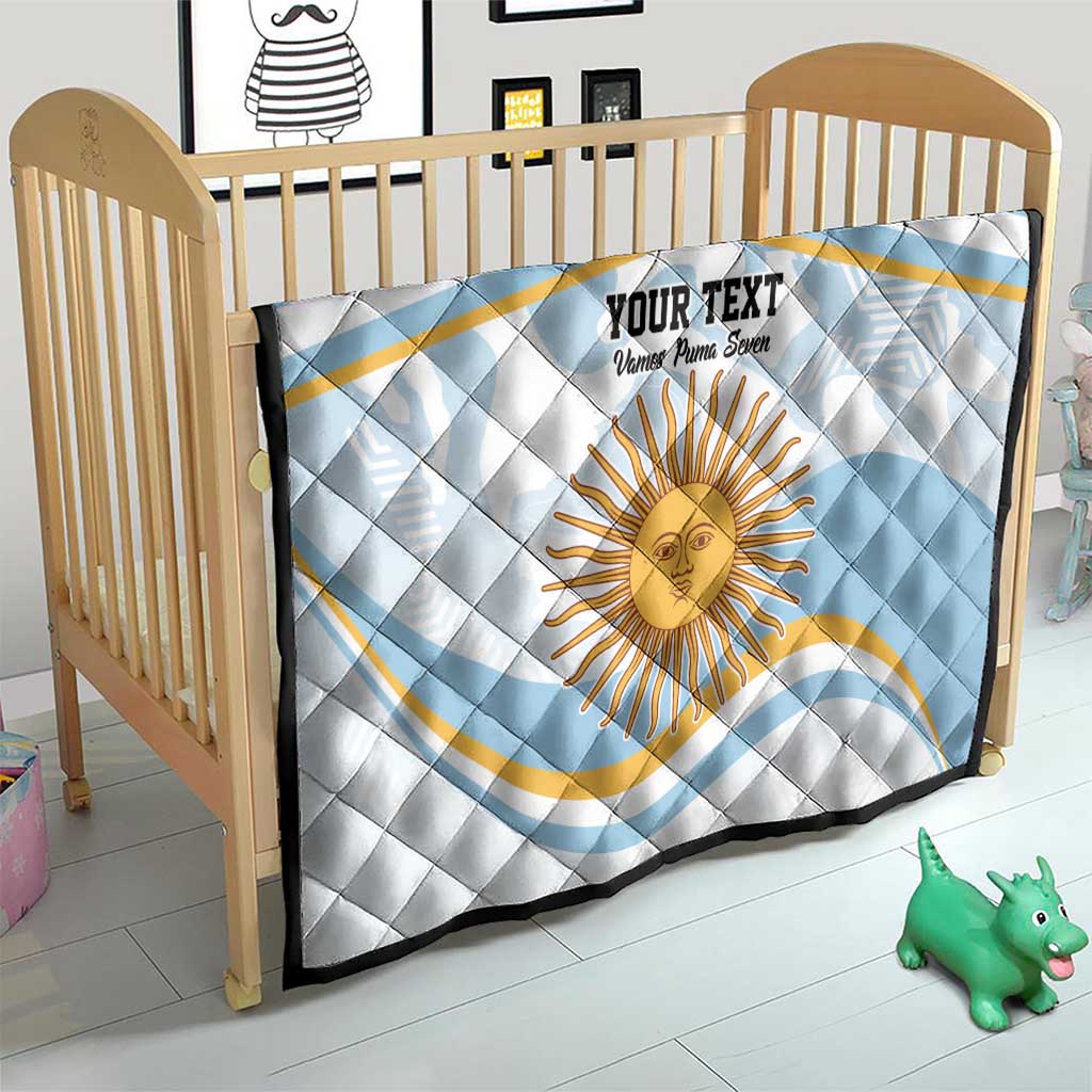 Light blue quilt on a wooden crib with Argentina sun face graphic and custom text