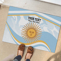 Blue custom doormat with sun emblem and custom text, on patio floor