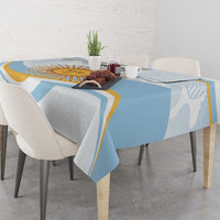 Light blue tablecloth with white and gold edge accents on a dining table