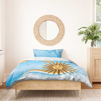 Blue duvet cover set with yellow sun logo, custom text, two pillowcases on wooden bed