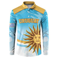 Blue long-sleeve rugby button sweatshirt with yellow collar; front “URUGUAY” sun graphic