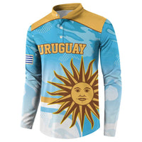 Blue long-sleeve rugby button sweatshirt with yellow collar; front “URUGUAY” sun emblem