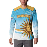 Blue long-sleeve rugby button sweatshirt with yellow collar; front “URUGUAY” sun graphic