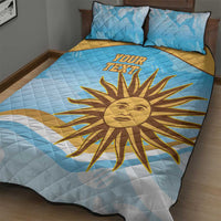 Blue quilt bed set with large yellow sun and 'YOUR TEXT' center, plus two pillows