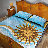 Blue quilt bed set with yellow sun and 'TEXT' lettering across quilt, two pillowcases