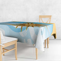 Blue tablecloth with gold sun-and-rays design, draped over a dining table