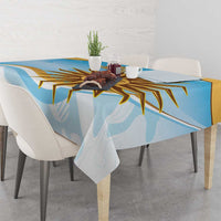 Blue tablecloth with gold sun graphic and abstract shapes, draped at table center