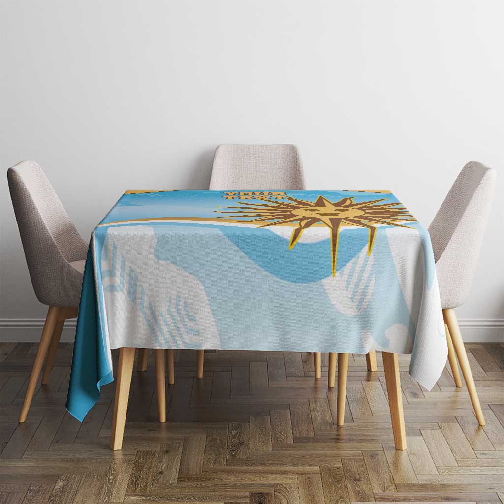 Blue tablecloth with gold sun design and abstract rays on a dining table