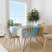 Blue tablecloth with gold sun graphic and abstract shapes on a dining table