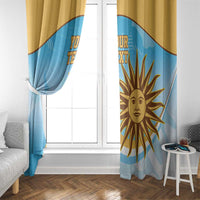 Window curtain panels in light blue with gold sun emblem, gathered at sides