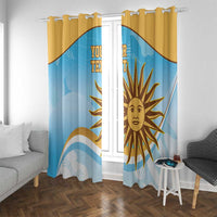 Window curtain panels in blue with gold sun emblem, hanging on rod