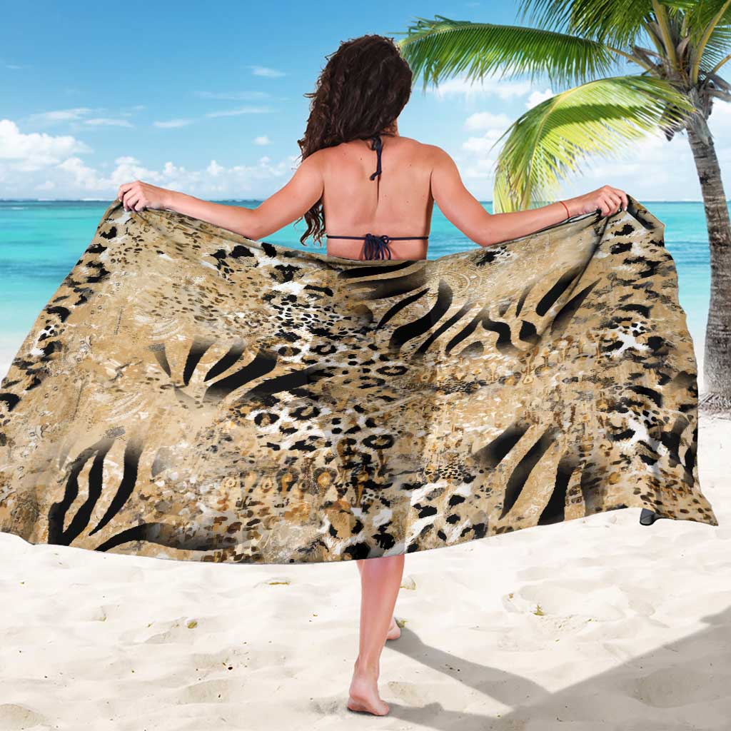 Beige animal-print sarong with bold black zebra and leopard motifs, worn draped