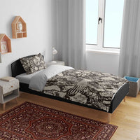 Snake-skin printed bedding set on bed: duvet cover and two pillowcases, black and cream