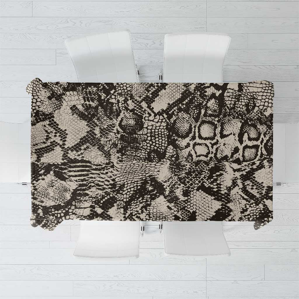 Black and white snake-and-crocodile print rectangular tablecloth on table with chairs