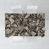 Black and white snake-and-crocodile print rectangular tablecloth on table with chairs
