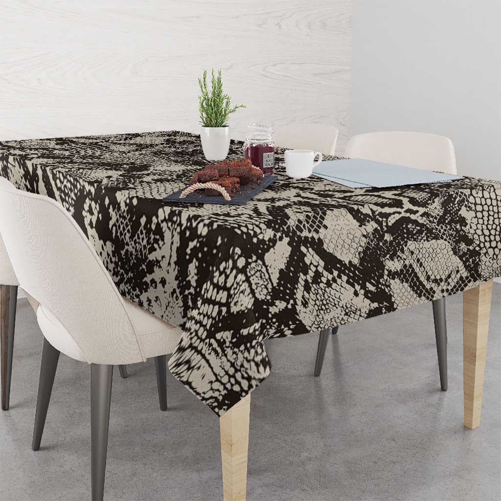 Snake-and-crocodile print tablecloth with patterned drape on dining table