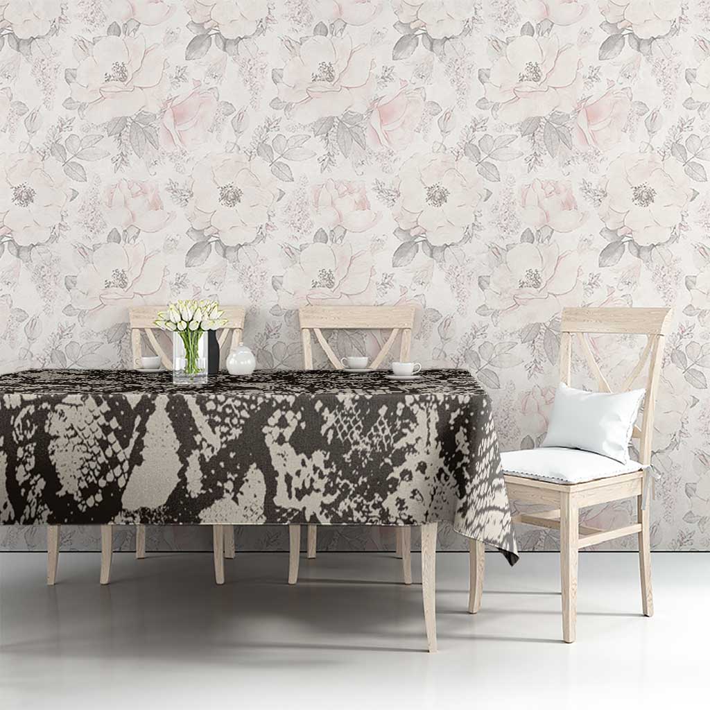 Black and white snake-and-crocodile print tablecloth on dining table with chairs