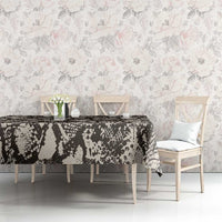 Black and white snake-and-crocodile print tablecloth on dining table with chairs
