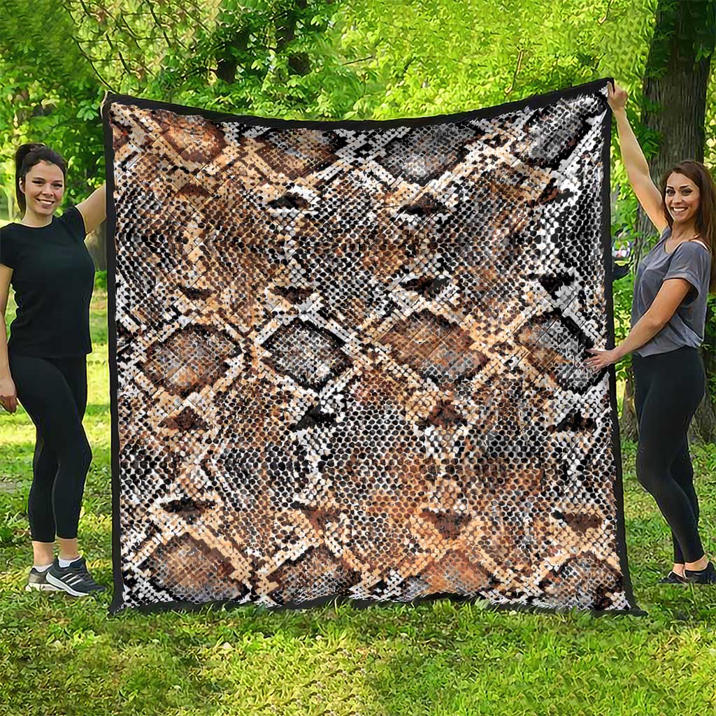 Snake-skin patterned quilt draped wide, beige tan with black and white diamond scales