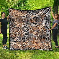 Snake-skin patterned quilt draped wide, beige tan with black and white diamond scales