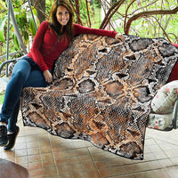Snake-skin patterned quilt spread out, beige tan with black and white diamond scales