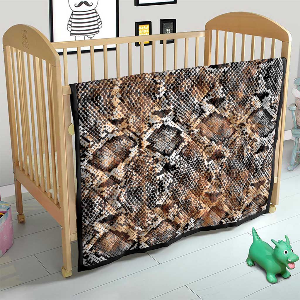 Snake-skin patterned quilt on small bed, beige tan with black and white diamond scales