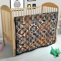 Snake-skin patterned quilt on small bed, beige tan with black and white diamond scales
