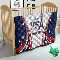 Personalized USA quilt on crib with navy star border, “TEAM USA” emblem and “YOUR TEXT”