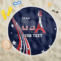Round blue beach blanket with USA flag, Eiffel Tower graphic, white fringe edge.