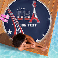 Round blue beach blanket with USA flag, Team US lettering, white fringe edge.