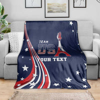 Blue fleece USA blanket on couch with Team USA emblem, star details, and custom text