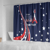 Blue shower curtain with vertical USA crest, Eiffel Tower icon, star pattern