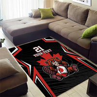 Area rug showing beaver holding a maple leaf, black with red/white stripes and 21