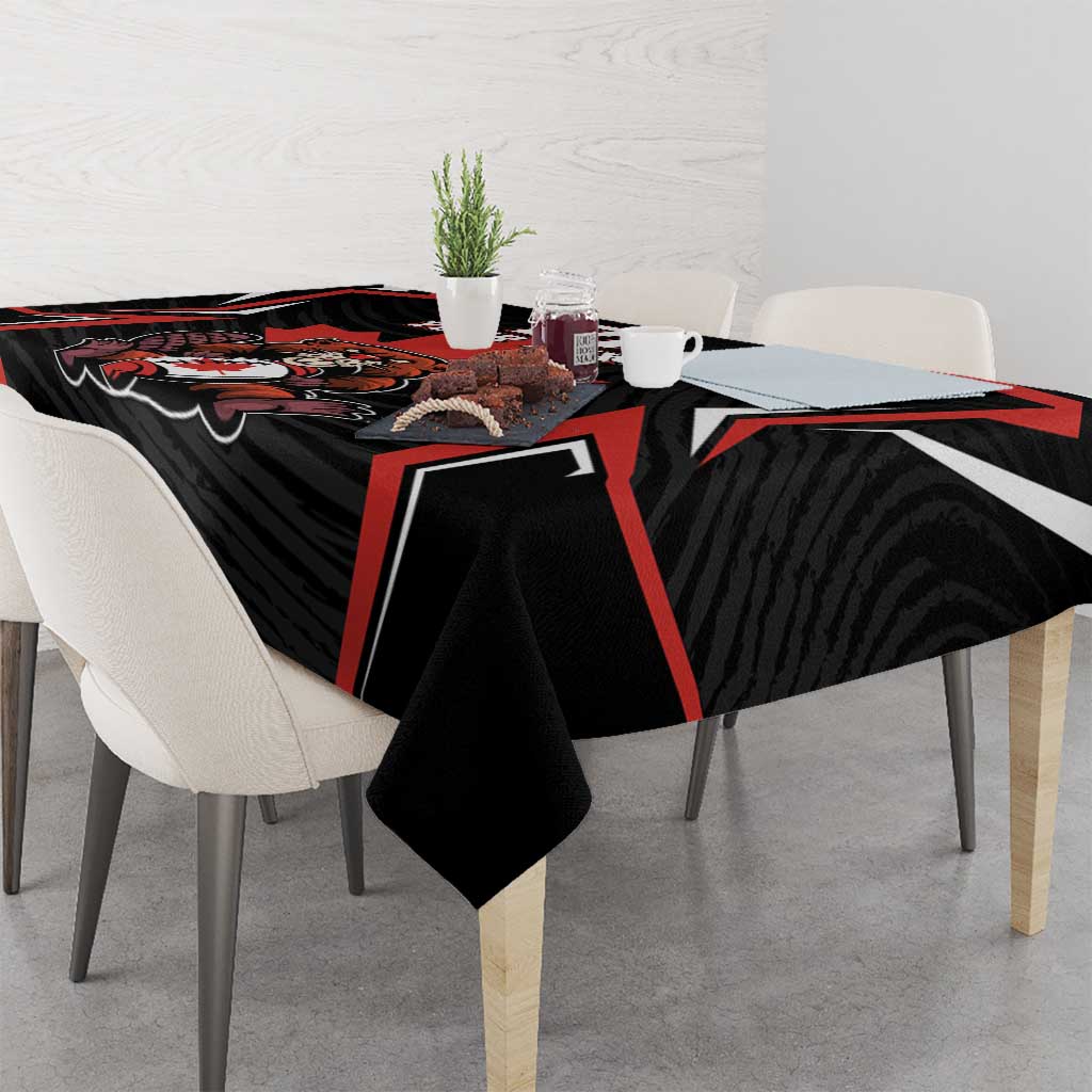 Black tablecloth on dining table with red-lined graphic and bold emblem centerpiece