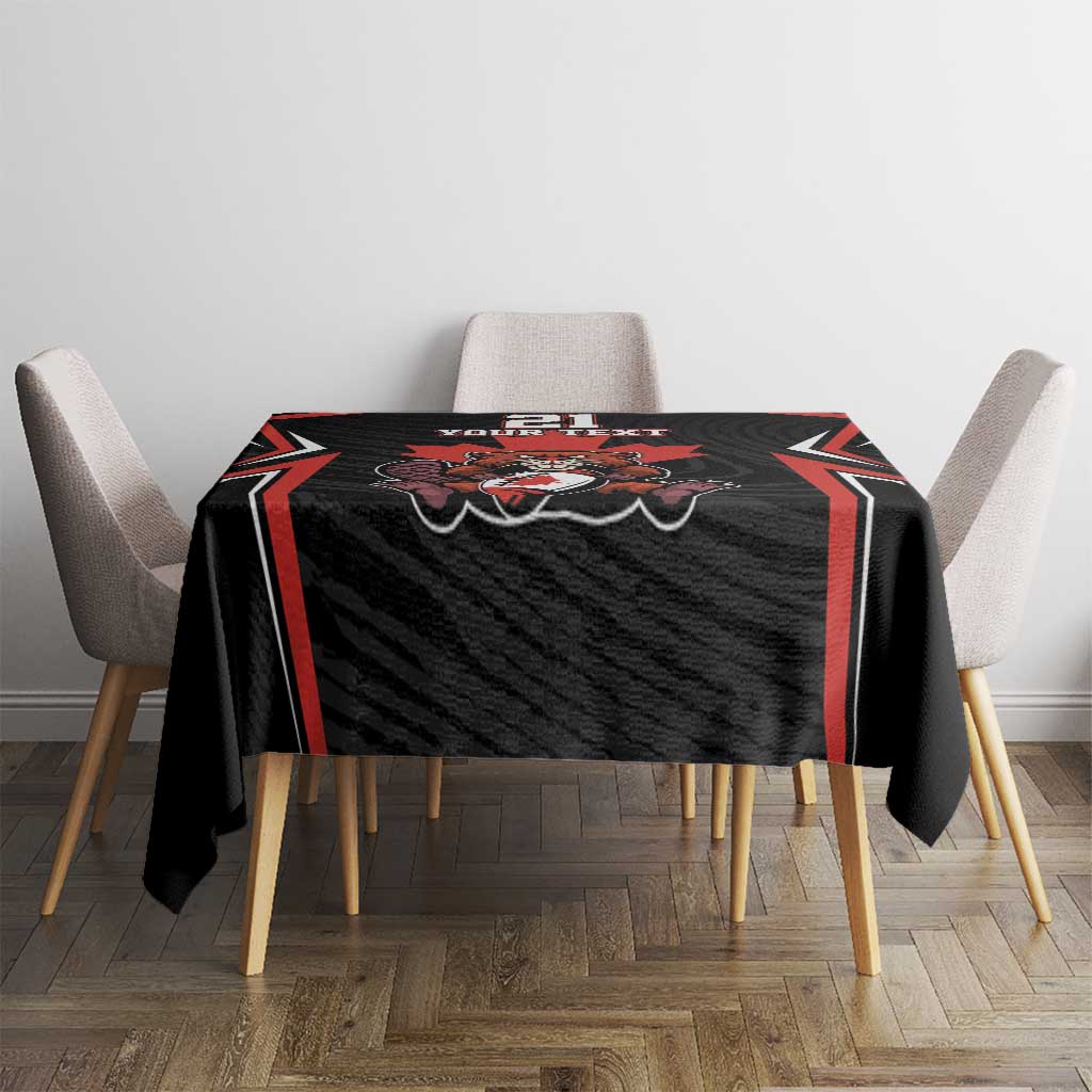 Black tablecloth with red-trim border and rugby-style crest in center