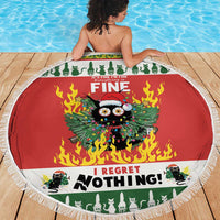 Red round beach blanket with white fringe, green border and cat-in-fire graphic.