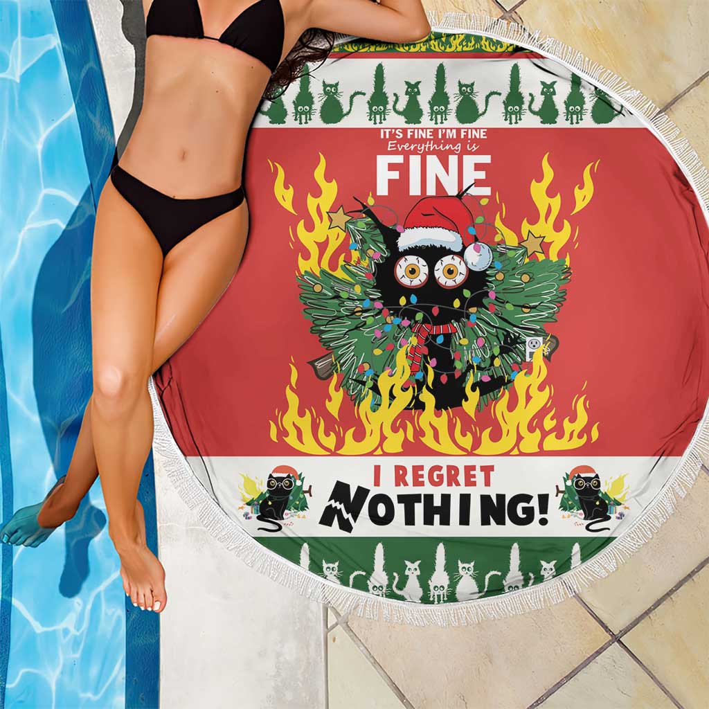 Red round beach blanket with white fringe and flaming cat design beside the pool.