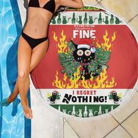 Red round beach blanket with white fringe and flaming cat design beside the pool.