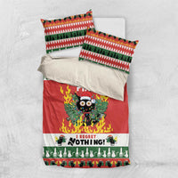 Christmas bedding set flat lay: red duvet with flaming owl graphic and green patterned pillowcases