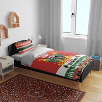 Christmas bedding set on bed with two pillowcases; red duvet with flaming owl and bold text