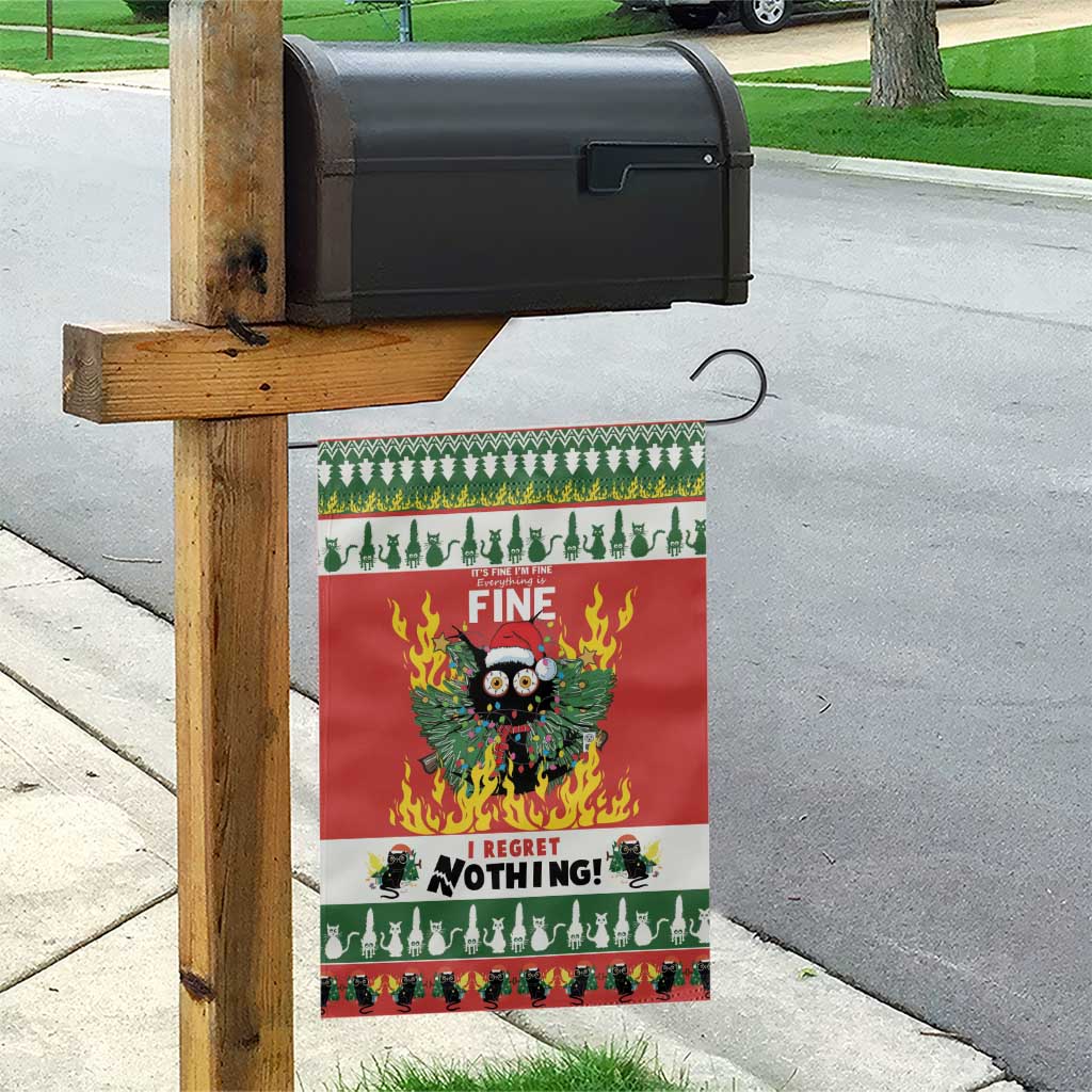 Red garden flag hanging on wooden post, green trim and cat-in-flames graphic, “I REGRET NOTHING!”