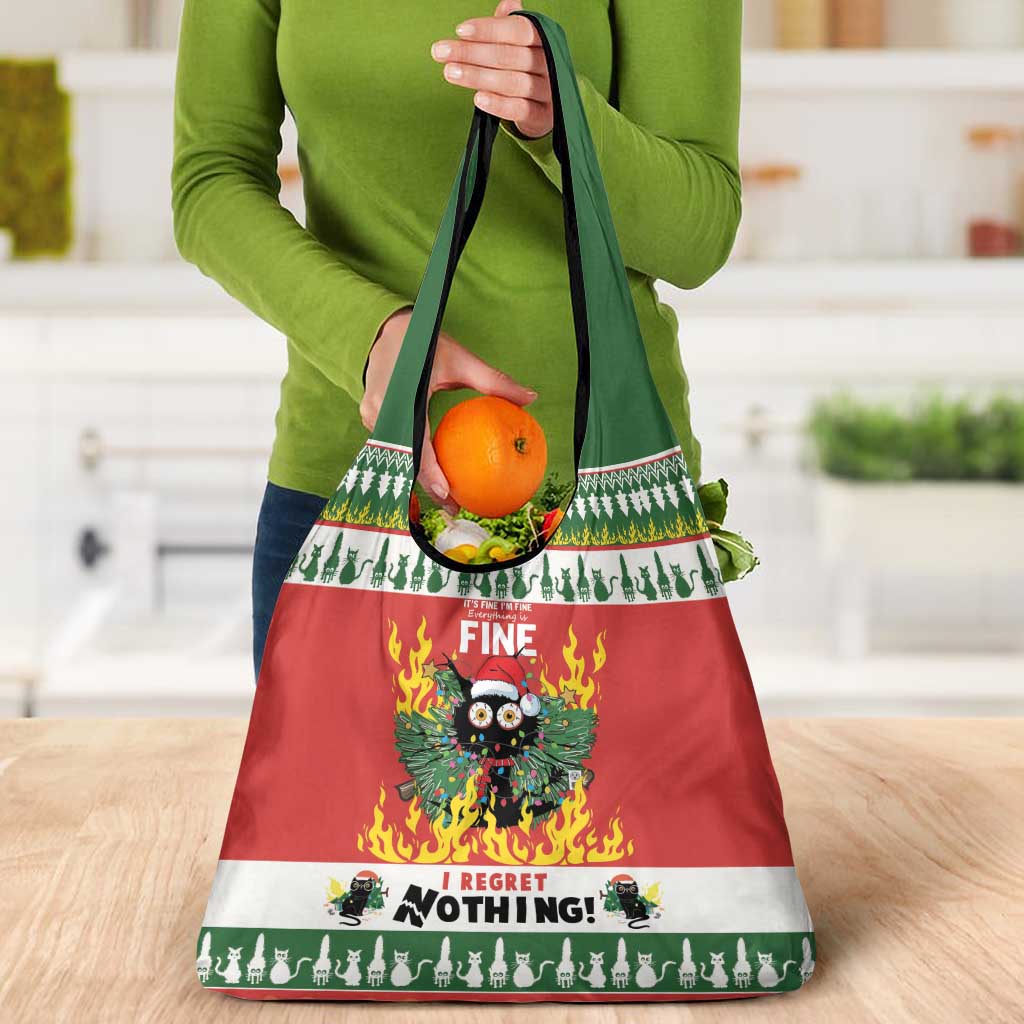 Red Christmas grocery tote bag with cat graphic and green top handles holding oranges