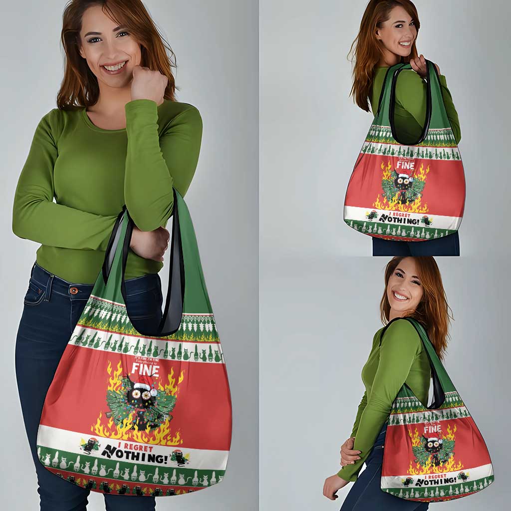 Person holding a red Christmas grocery tote bag with cat graphic and green handles