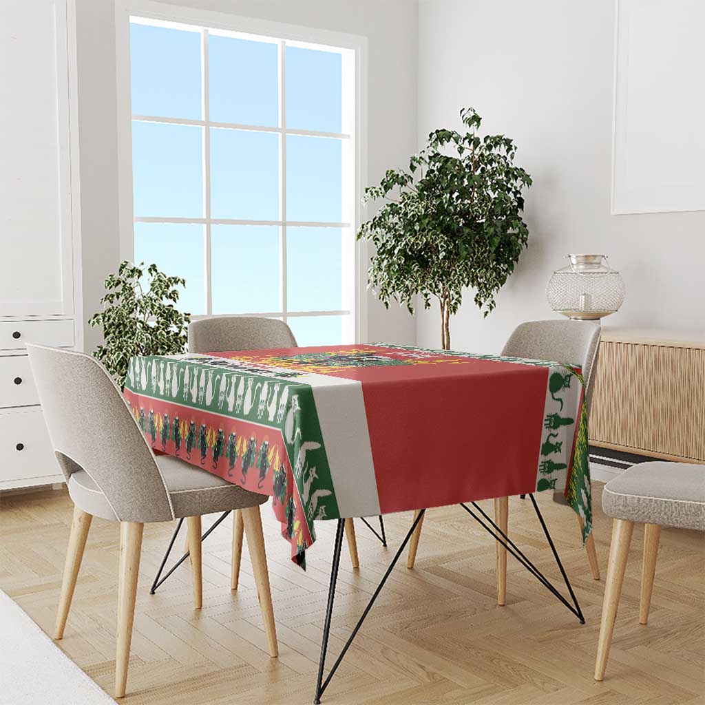 Red and green Christmas cat tablecloth draped over dining table edge with fringe border