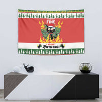 Red Christmas wall tapestry with flaming cat graphic on white wall above cabinet