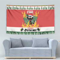 Red Christmas wall tapestry with flaming cat graphic above light gray sofa