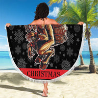Round beach blanket with white fringe, dark Krampus illustration, red banner and snowflakes
