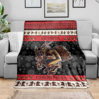 Red and black Krampus Christmas blanket with central demon illustration and striped borders