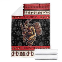 Krampus Christmas blanket with red patterned top border, black center with demon, and cream base
