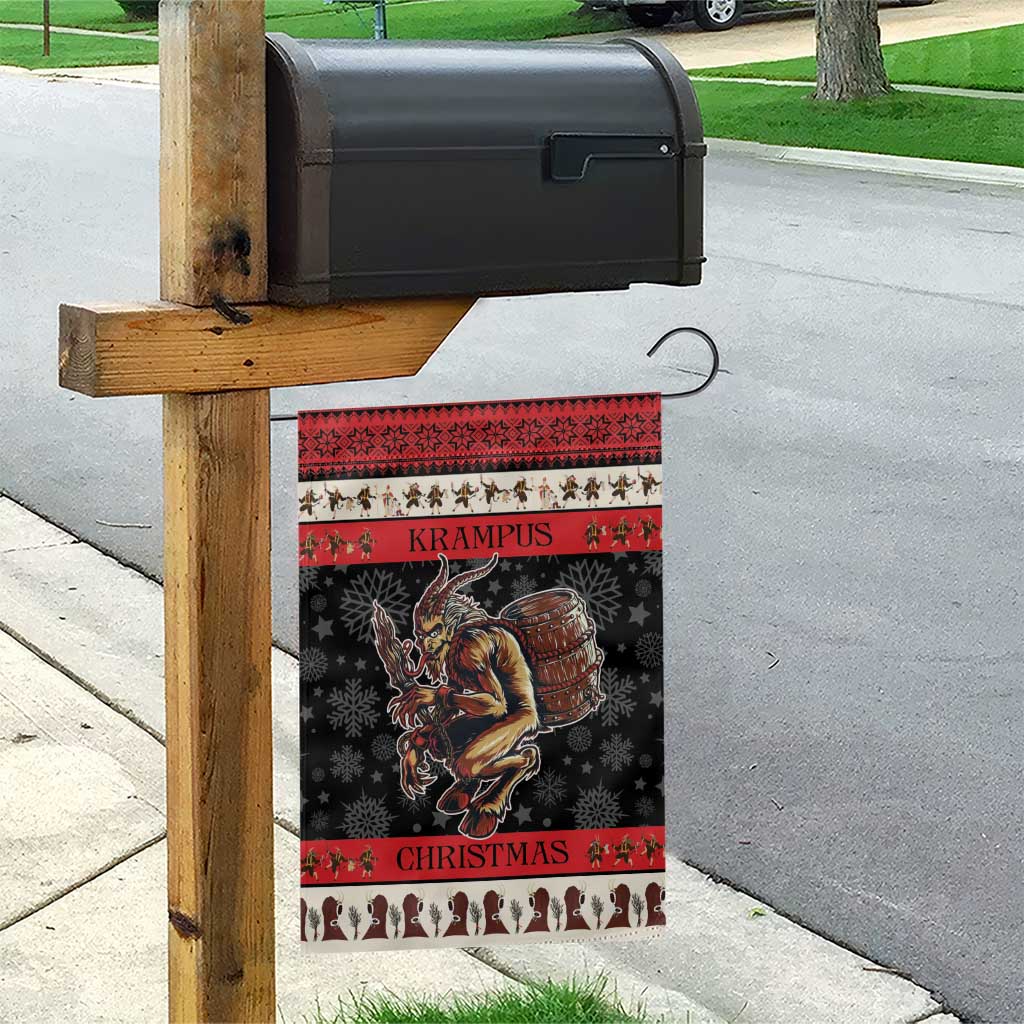 Krampus Christmas garden flag hanging on wooden post, dark with red trim and patterned border